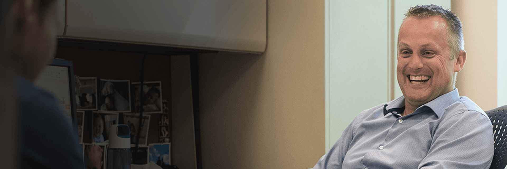 photo of jason stoter talking to co worker in his office