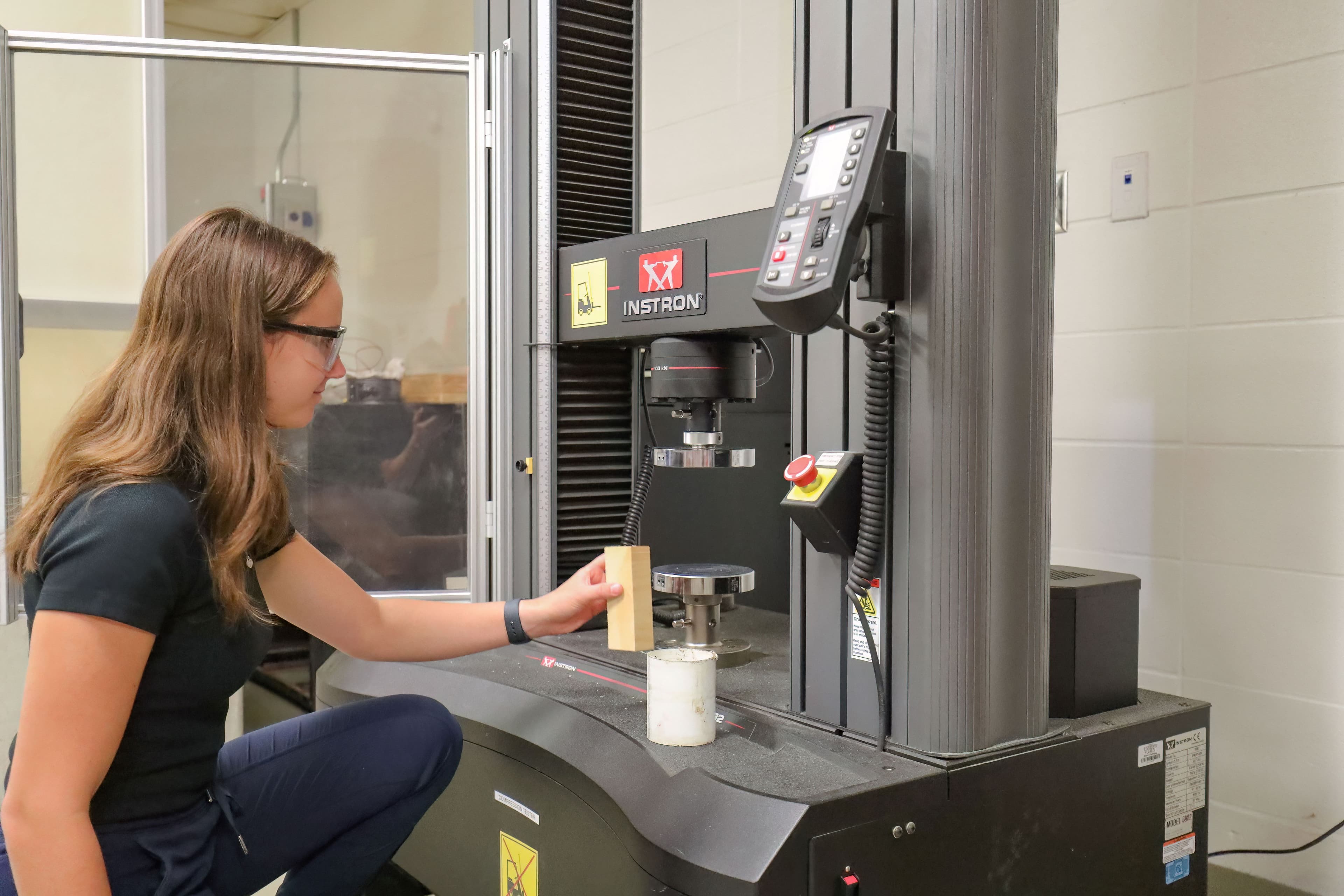 Student in the Engineering Lab using a testing system.