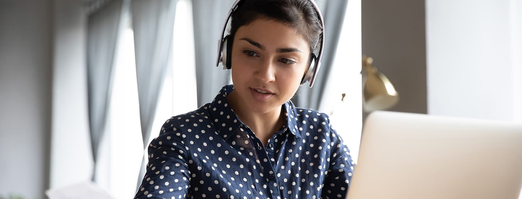 Young woman studying on a laptop.