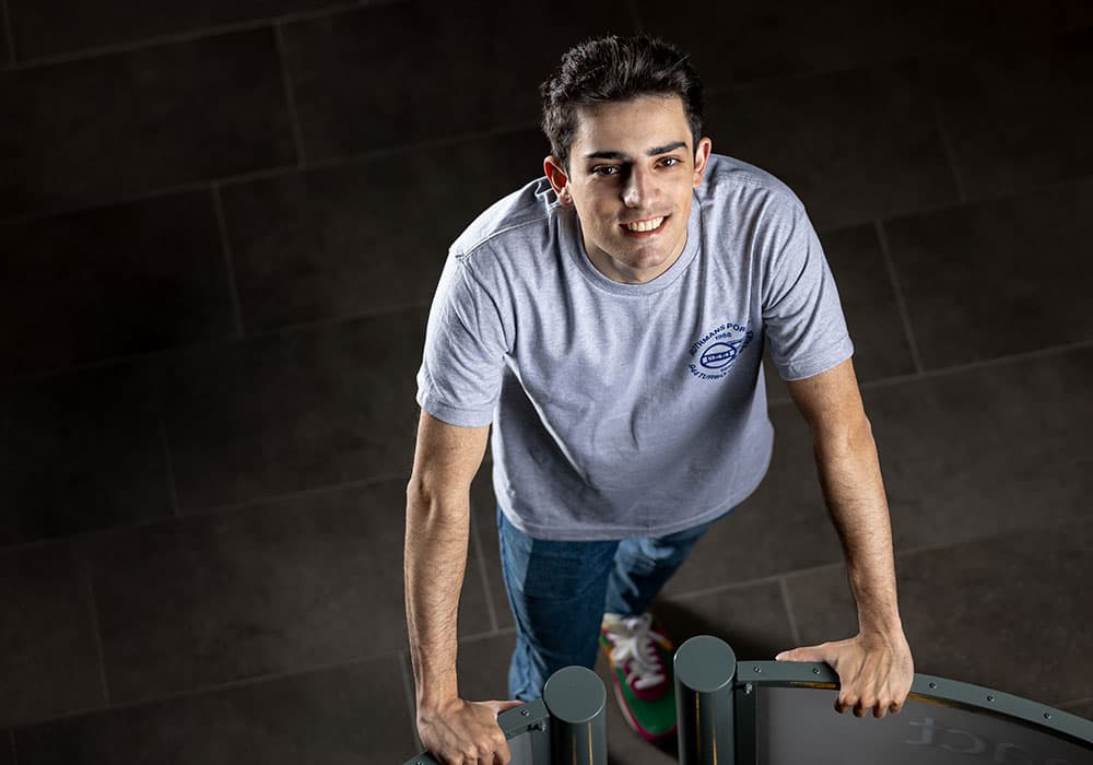 Lang business school alumni Toygar Yildirim in Macdonald Hall looking up.