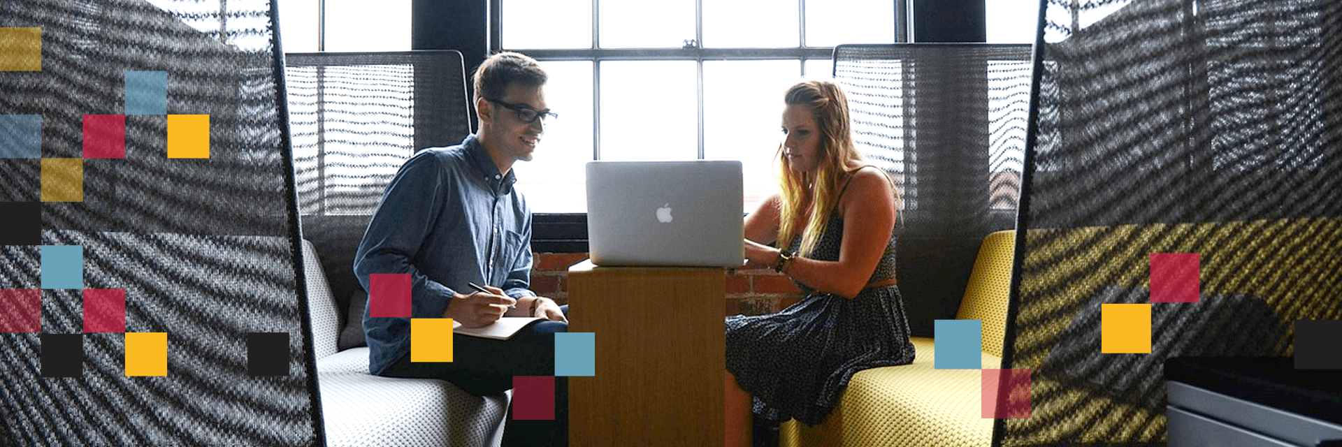two entrepreneurs looking at a computer together