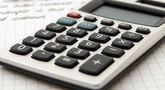 Calculator on top of a notepad with writing