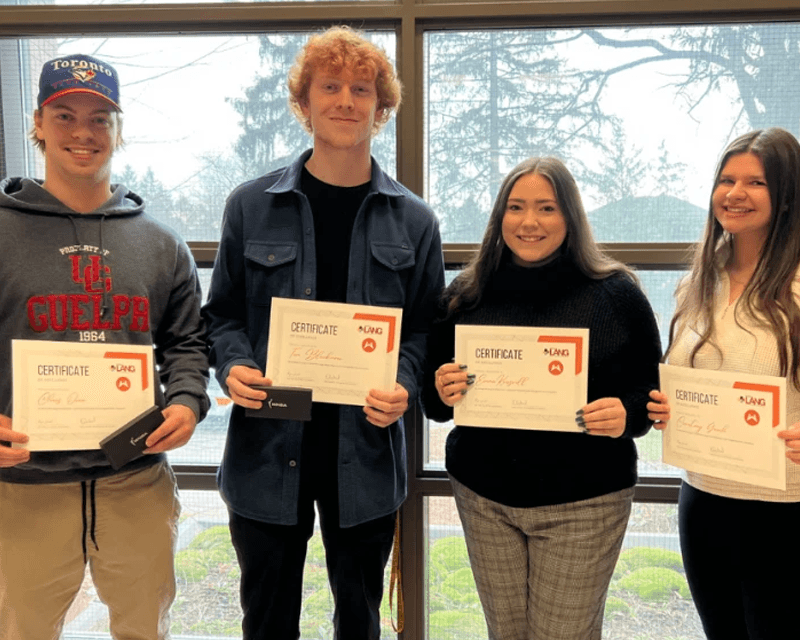 students holding a certificate