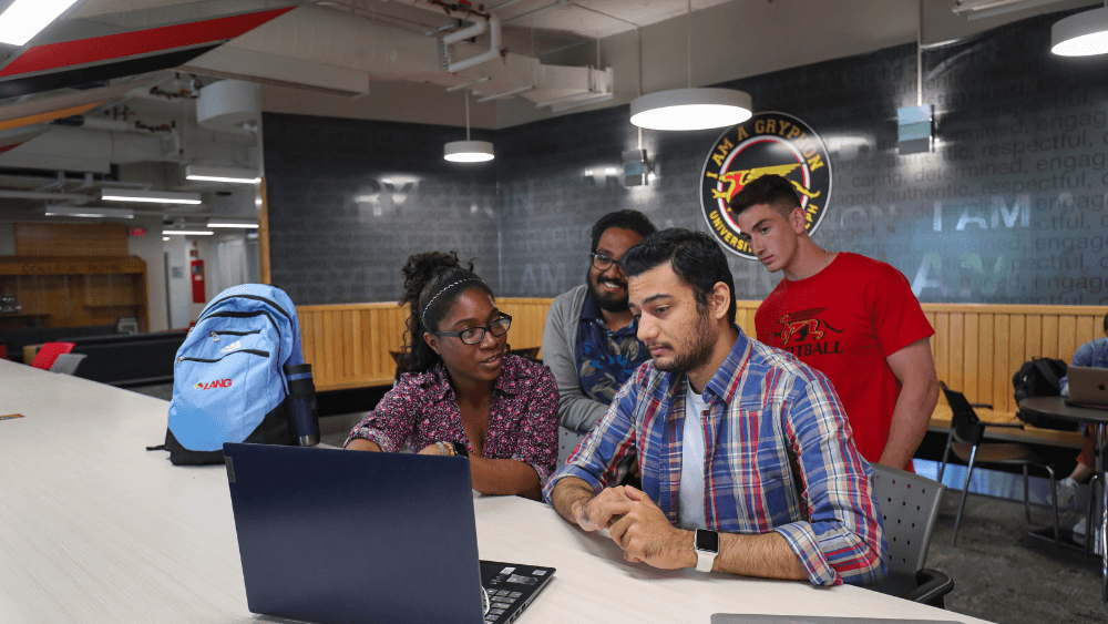 Four students in the UC around a computer.