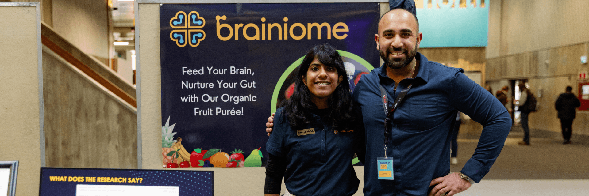 2 people standing in front of a poster board