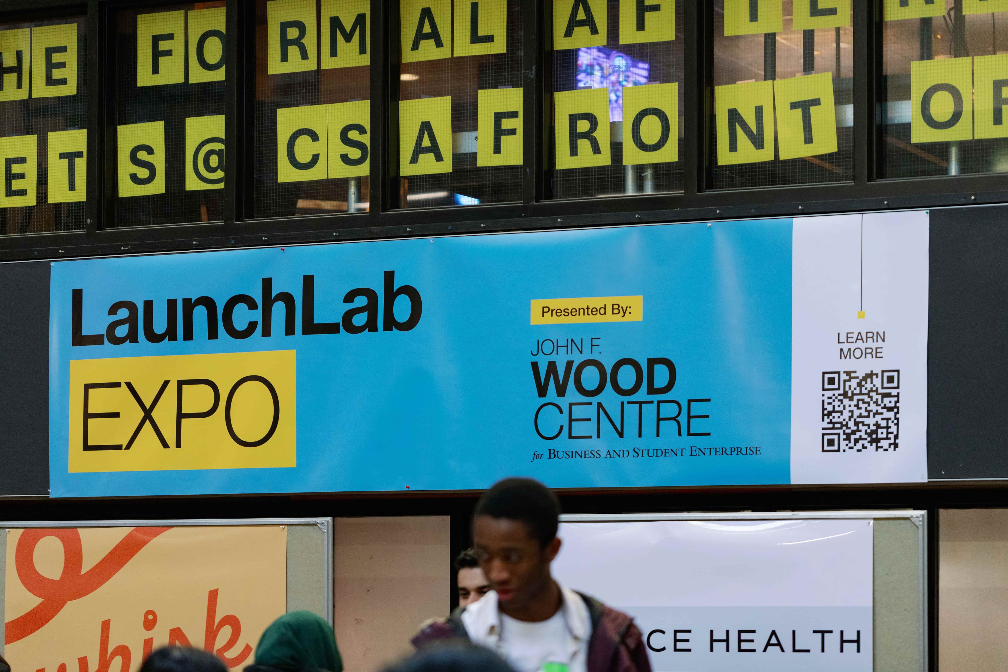 Blue background with a black and yellow logo with text that reads' LaunchLab Expo'