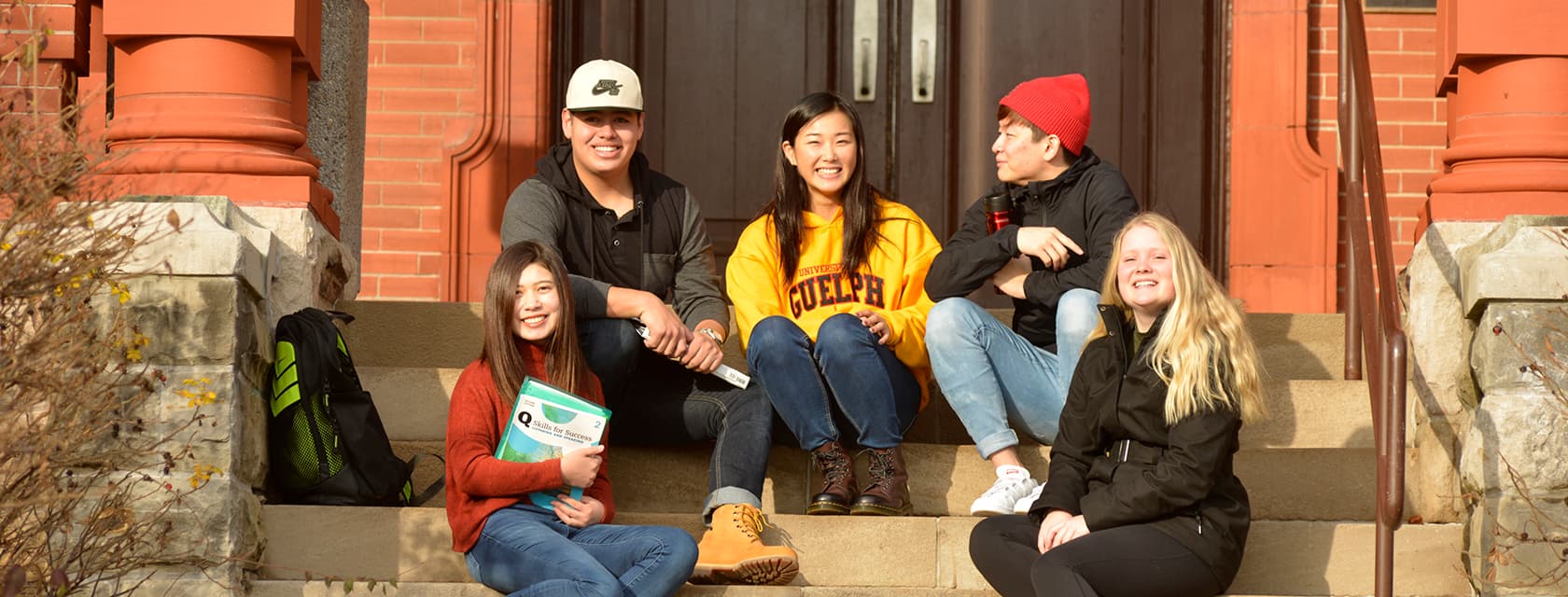 English Language Programs students sitting on steps on campus.