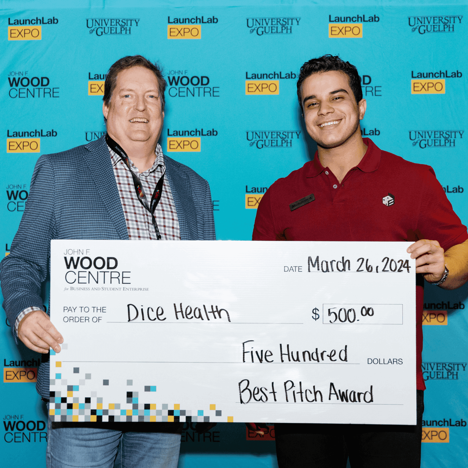 2 individuals holding cheque
