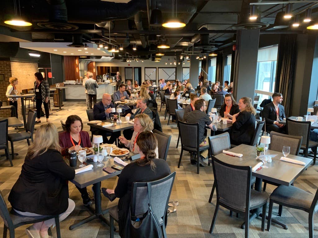 Conference attendees eating breakfast at the University Club.